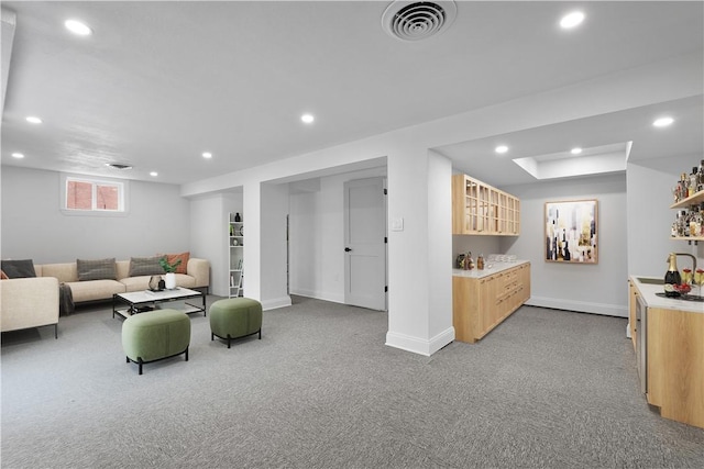 living room with indoor bar and light colored carpet