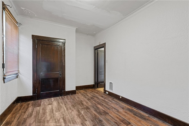 unfurnished room featuring dark hardwood / wood-style floors and ornamental molding