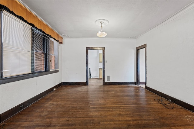 unfurnished room featuring ornamental molding, a textured ceiling, and dark wood-type flooring