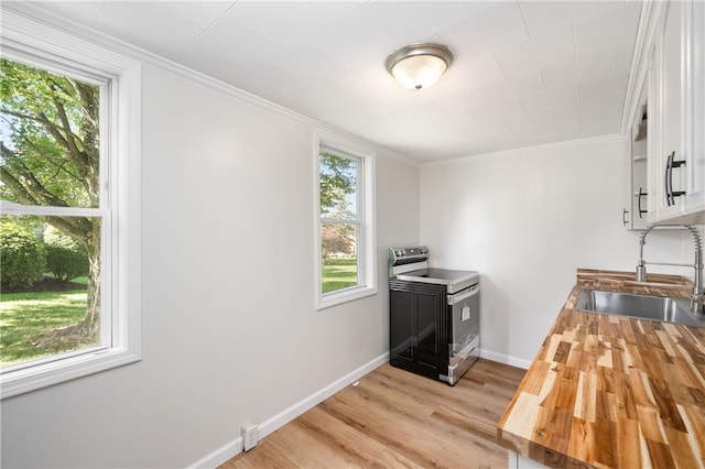 kitchen with light hardwood / wood-style floors, sink, white cabinets, electric stove, and ornamental molding