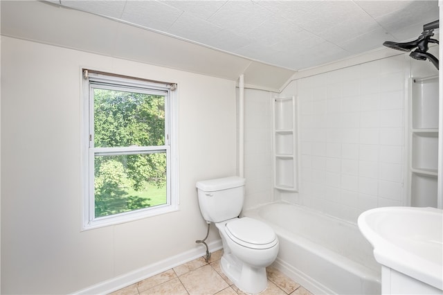 full bathroom with vanity, tiled shower / bath, tile patterned floors, and toilet