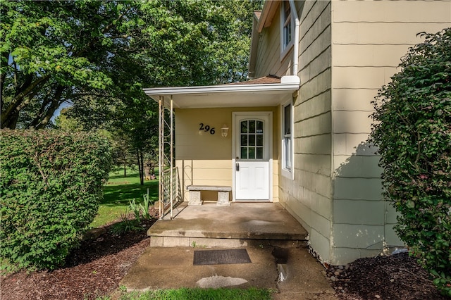 view of exterior entry featuring a yard