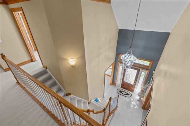 entrance foyer with a notable chandelier and a towering ceiling