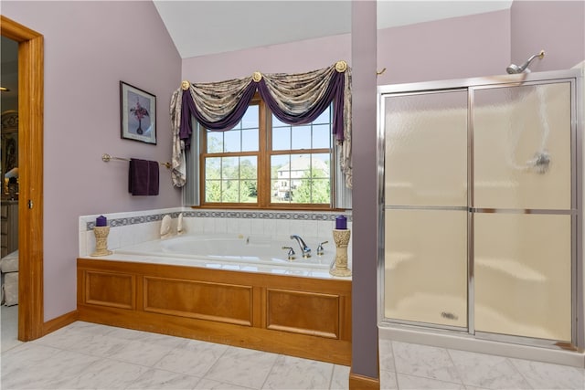 bathroom featuring plus walk in shower and vaulted ceiling