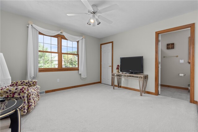 living area with ceiling fan and light carpet