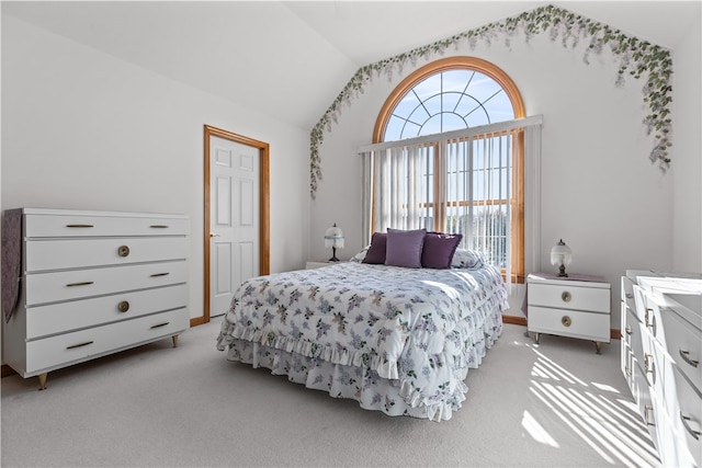 carpeted bedroom with vaulted ceiling