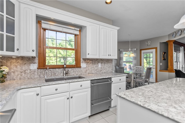 kitchen featuring white cabinetry, sink, pendant lighting, and plenty of natural light