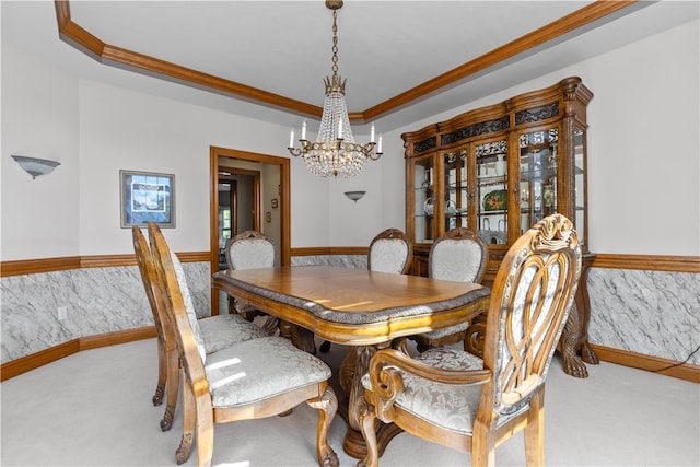 carpeted dining room with crown molding and an inviting chandelier