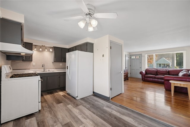 kitchen with tasteful backsplash, white appliances, ceiling fan, light hardwood / wood-style flooring, and sink