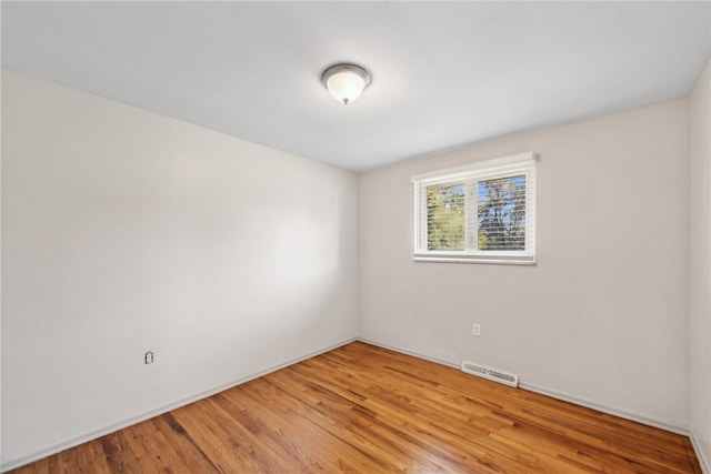 spare room featuring wood-type flooring