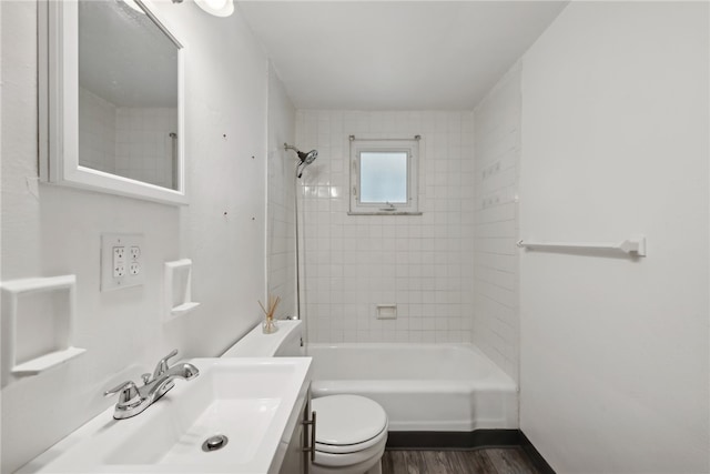 full bathroom featuring wood-type flooring, vanity, toilet, and tiled shower / bath