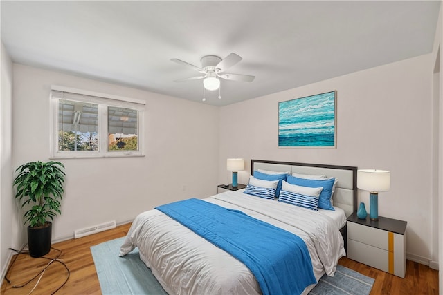 bedroom with ceiling fan and hardwood / wood-style floors