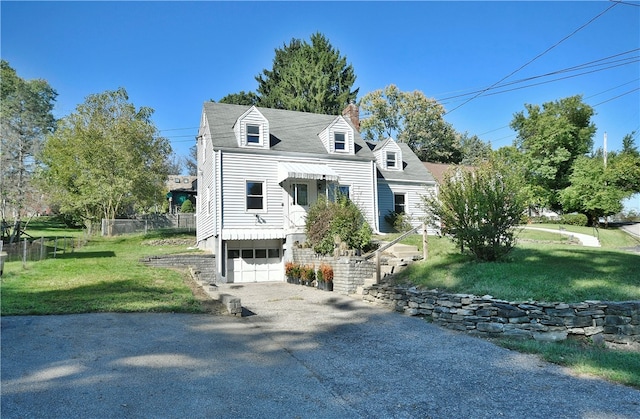 new england style home with a garage and a front lawn