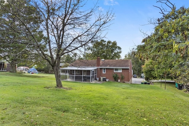 view of yard with a sunroom