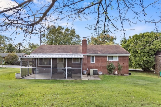 back of house with a sunroom, a lawn, a patio, and central AC