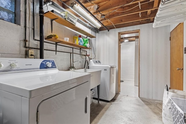 clothes washing area featuring washing machine and dryer and sink