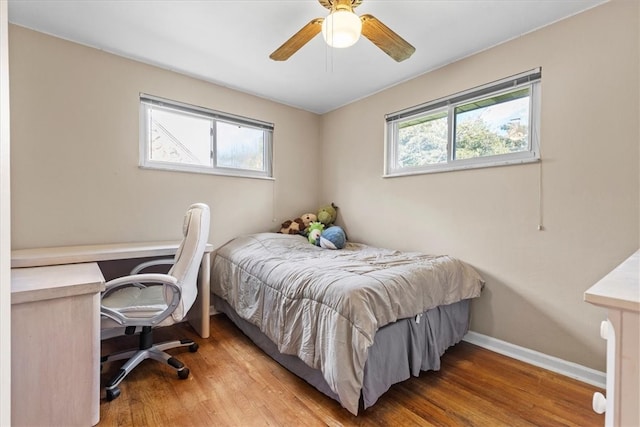 bedroom with light hardwood / wood-style floors and ceiling fan