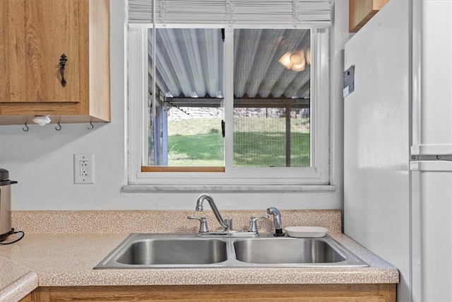 kitchen with white refrigerator and sink