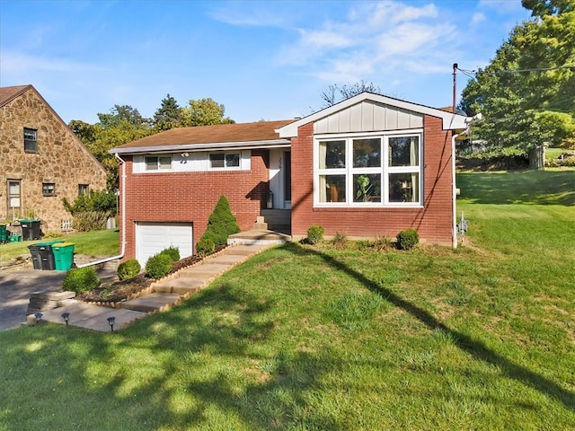 view of front of home with a front yard and a garage