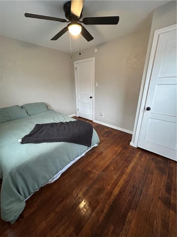 bedroom featuring ceiling fan and dark hardwood / wood-style floors