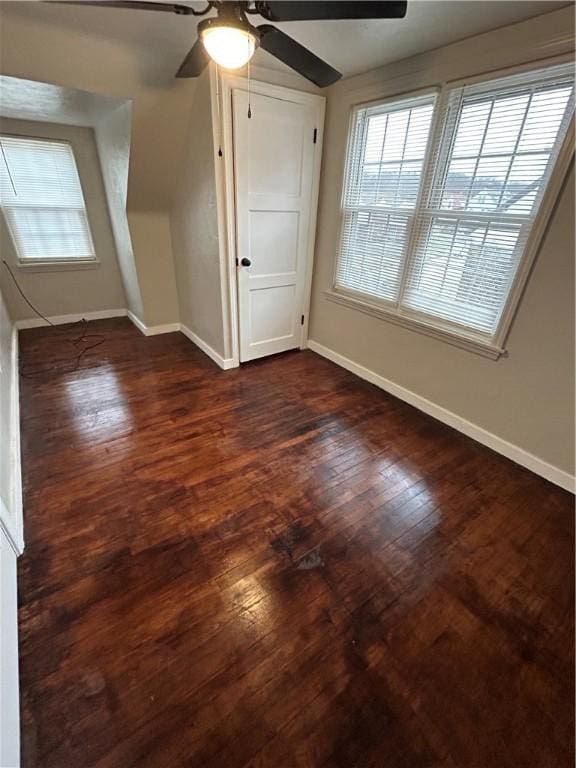 bonus room with dark hardwood / wood-style floors and ceiling fan