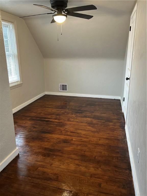 bonus room featuring ceiling fan, dark wood-type flooring, and vaulted ceiling