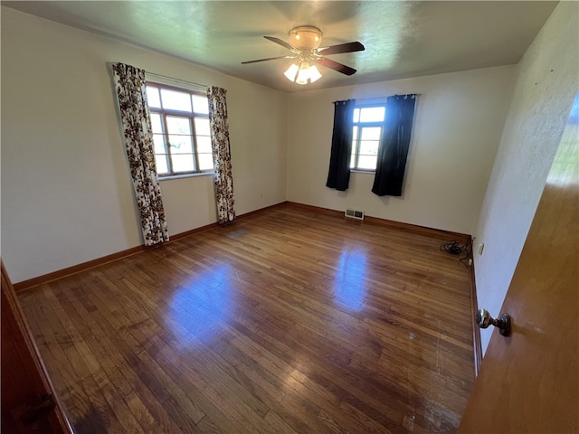 unfurnished room featuring ceiling fan and hardwood / wood-style floors