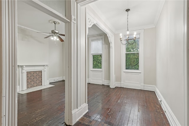 interior space featuring crown molding, ceiling fan with notable chandelier, and dark hardwood / wood-style flooring