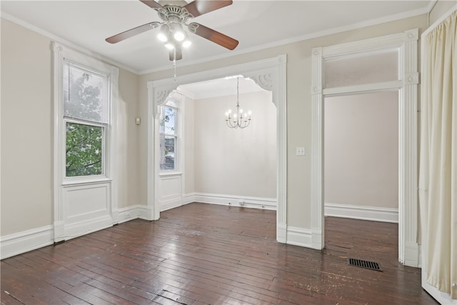 unfurnished dining area with ceiling fan with notable chandelier, dark wood-type flooring, and crown molding