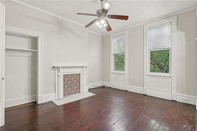 unfurnished living room featuring ceiling fan, crown molding, and dark hardwood / wood-style flooring