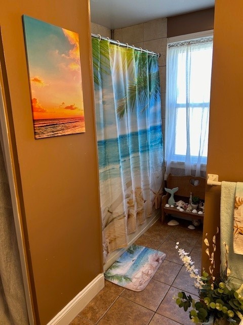 bathroom featuring a shower with shower curtain and tile patterned floors