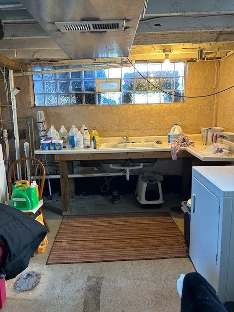 miscellaneous room with concrete flooring and sink