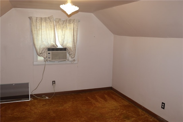 bonus room featuring dark colored carpet and vaulted ceiling