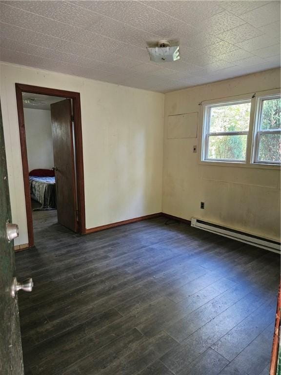131 Overlook Dr Unit B, Slippery Rock Twp But, PA 16057 - empty room featuring baseboard heating, dark wood-style floors, and baseboards