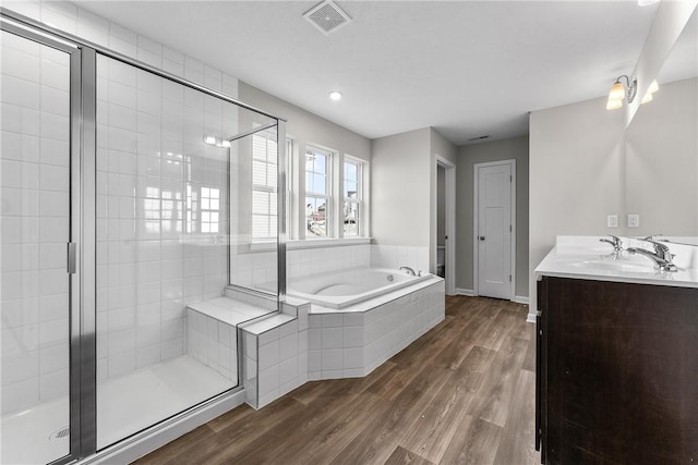 bathroom featuring vanity, hardwood / wood-style flooring, and independent shower and bath