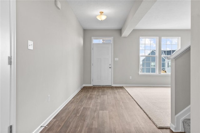 foyer with hardwood / wood-style flooring and beam ceiling