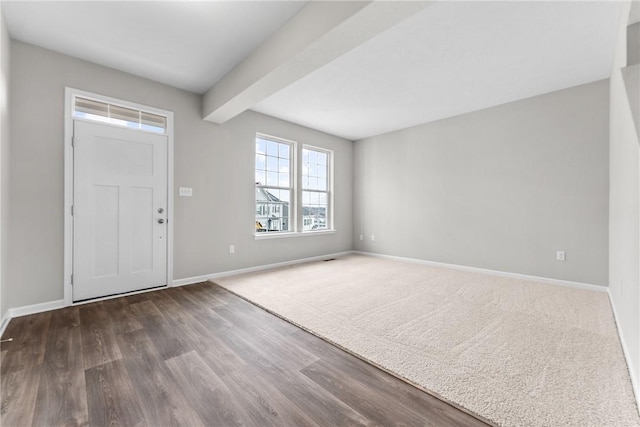 foyer entrance with dark hardwood / wood-style flooring and beamed ceiling