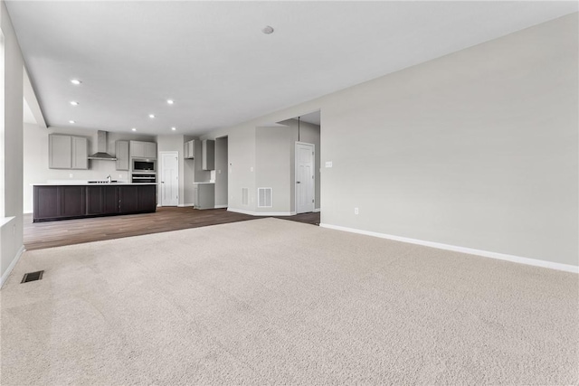 unfurnished living room with carpet floors