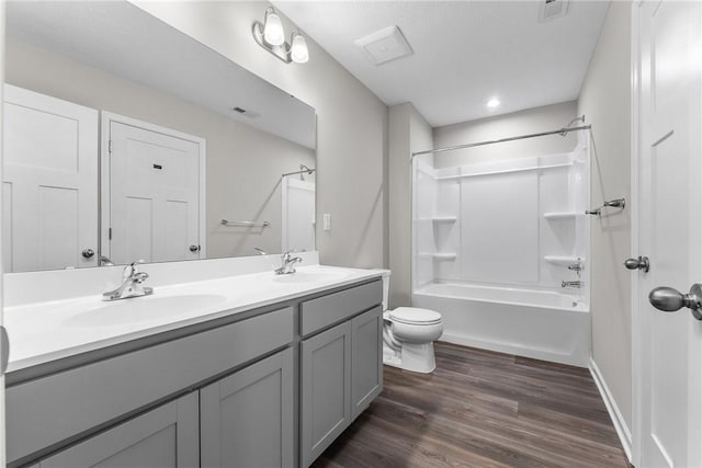 full bathroom featuring hardwood / wood-style floors, vanity, toilet, and shower / bathing tub combination