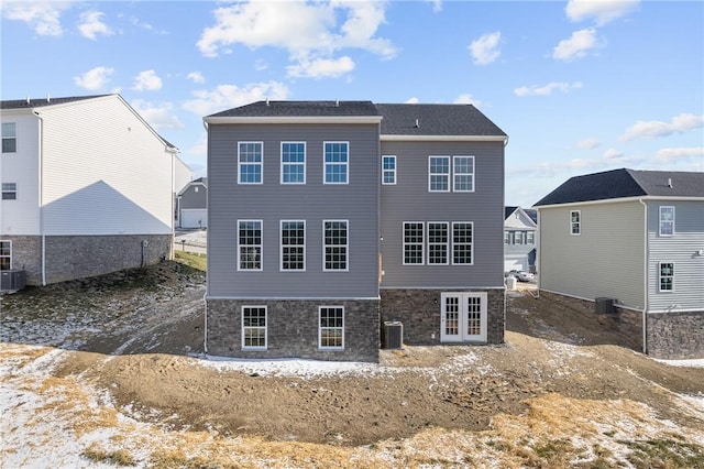 back of property with french doors and central AC unit