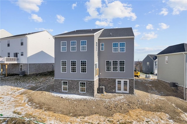 rear view of property with french doors and central AC unit