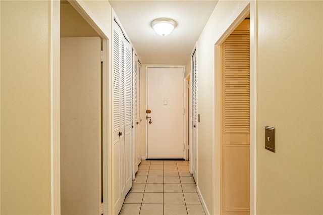 hall featuring light tile patterned floors