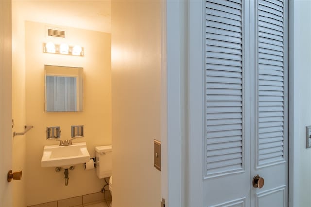 bathroom with sink, tile patterned flooring, and toilet