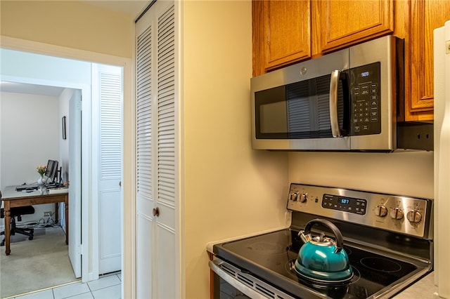 kitchen with appliances with stainless steel finishes and light tile patterned floors