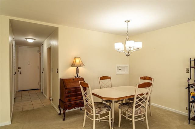 carpeted dining room featuring a chandelier