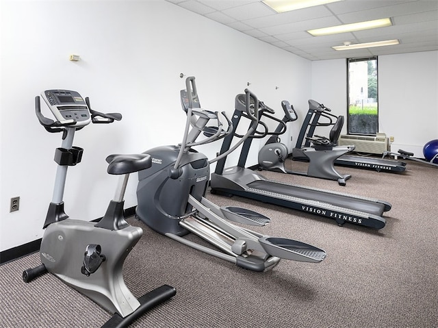 workout area with a paneled ceiling