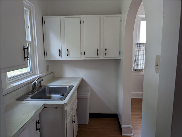 kitchen with white cabinets, dark hardwood / wood-style flooring, a healthy amount of sunlight, and sink