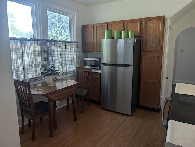 kitchen featuring appliances with stainless steel finishes and dark wood-type flooring