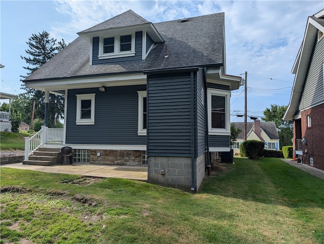 back of property featuring a yard and central AC unit