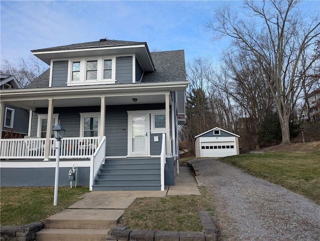 view of front of property with a porch, a front yard, an outdoor structure, and a garage